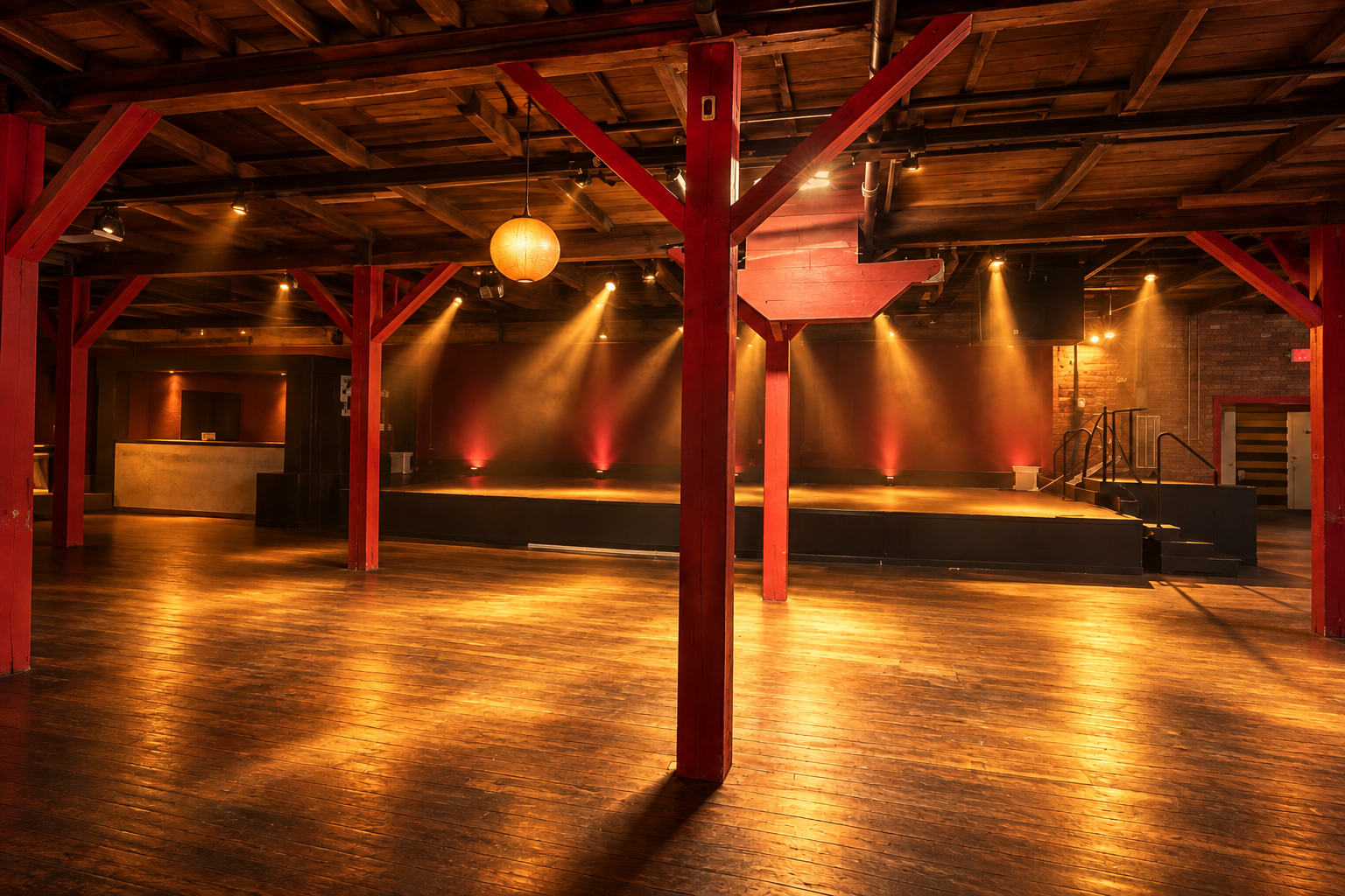 Grant Street Dancehall interior with red timber beams, wood dance floor and rear stage; enhanced concept lighting